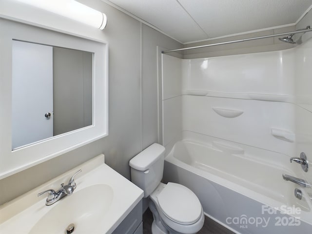 full bathroom with vanity, a textured ceiling, bathtub / shower combination, and toilet