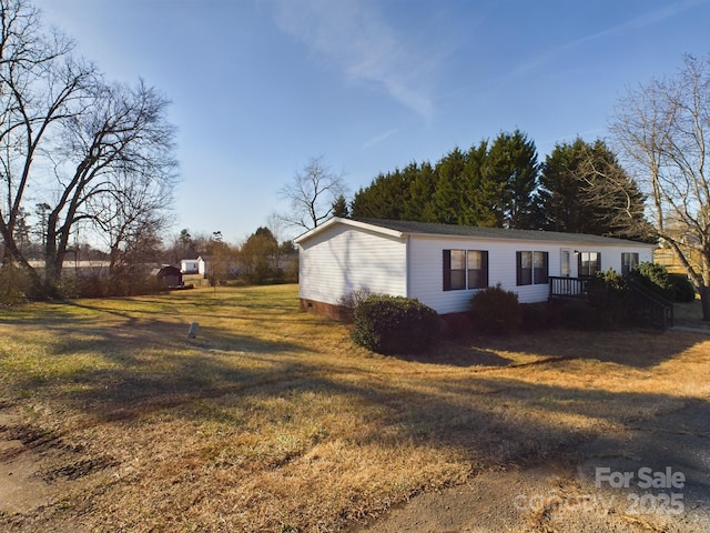 view of side of home with a lawn