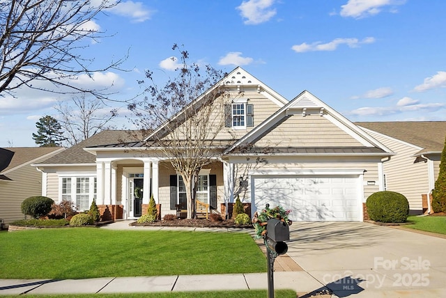 craftsman house featuring covered porch, a garage, and a front yard