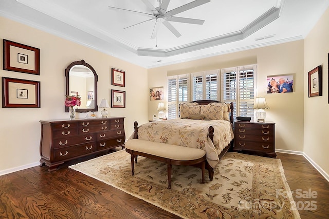 bedroom featuring ceiling fan, dark hardwood / wood-style floors, and a raised ceiling