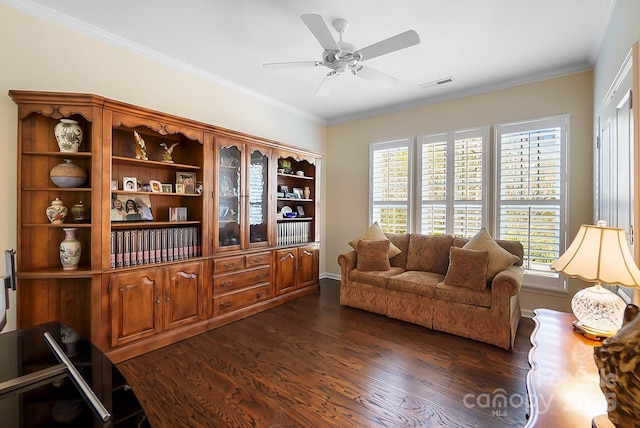 living room featuring a wealth of natural light, crown molding, ceiling fan, and dark wood-type flooring