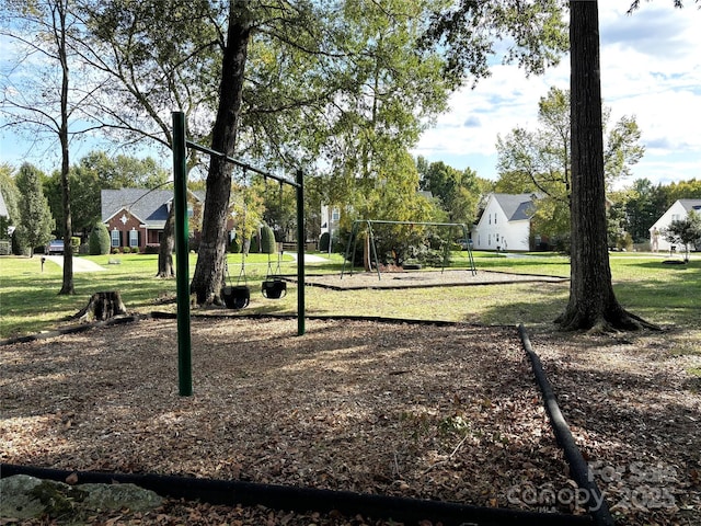 view of home's community with a playground and a lawn