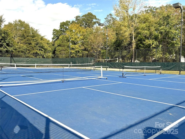 view of tennis court featuring basketball hoop