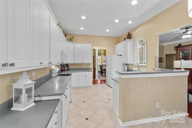 kitchen with white appliances, crown molding, ceiling fan, light tile patterned floors, and white cabinetry