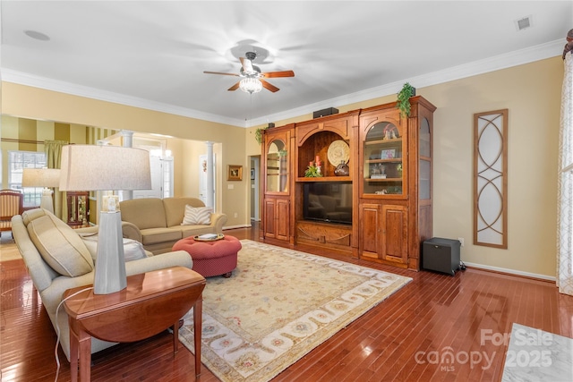 living room featuring ceiling fan, dark hardwood / wood-style floors, and crown molding