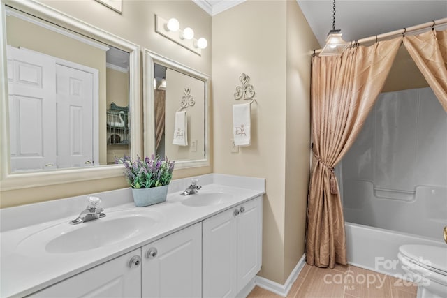 full bathroom featuring crown molding, shower / tub combo with curtain, vanity, and toilet