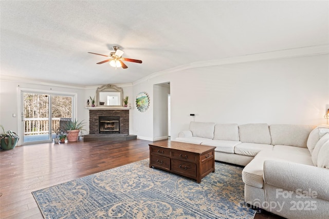 living room with ceiling fan, hardwood / wood-style floors, crown molding, and a textured ceiling