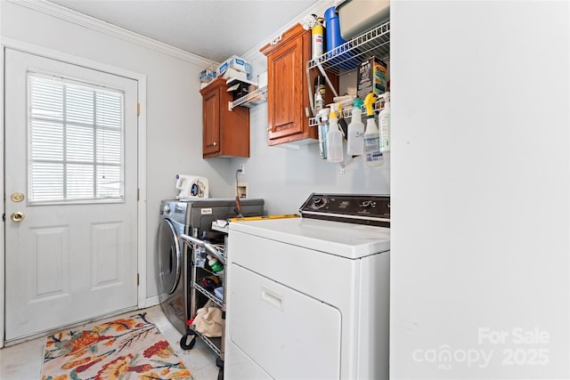 laundry room with cabinets, independent washer and dryer, and crown molding