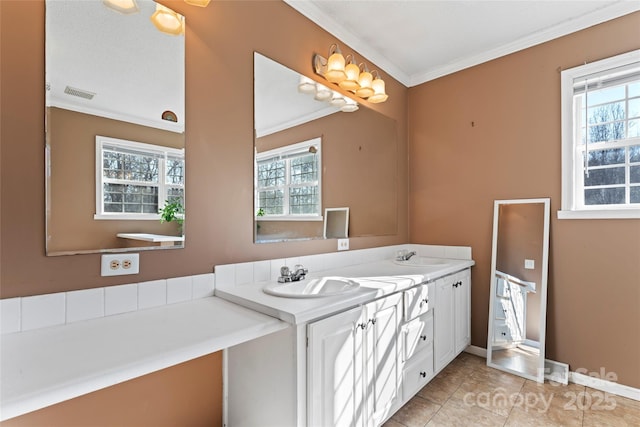 bathroom featuring tile patterned floors, vanity, crown molding, and a wealth of natural light