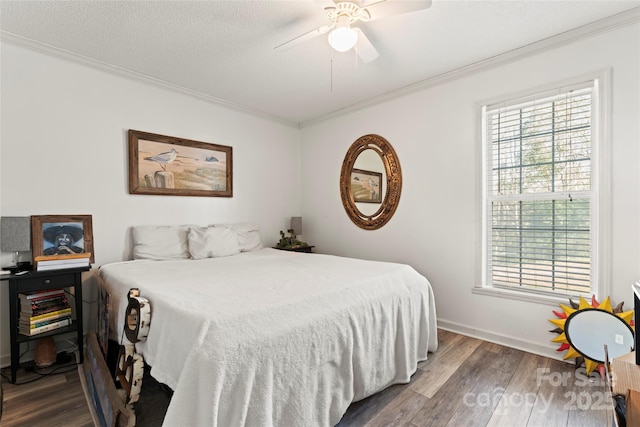 bedroom with a textured ceiling, crown molding, ceiling fan, and dark wood-type flooring