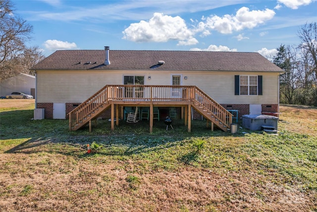 rear view of property with a deck and a lawn