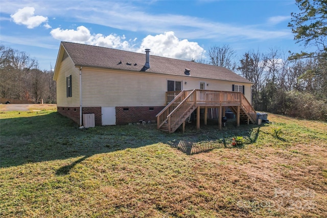 back of house with a yard and a wooden deck