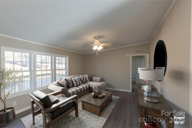 living room with a wealth of natural light, dark hardwood / wood-style floors, and ornamental molding