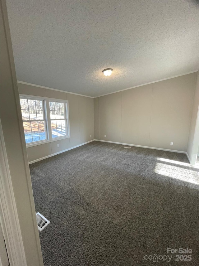 carpeted empty room with a textured ceiling