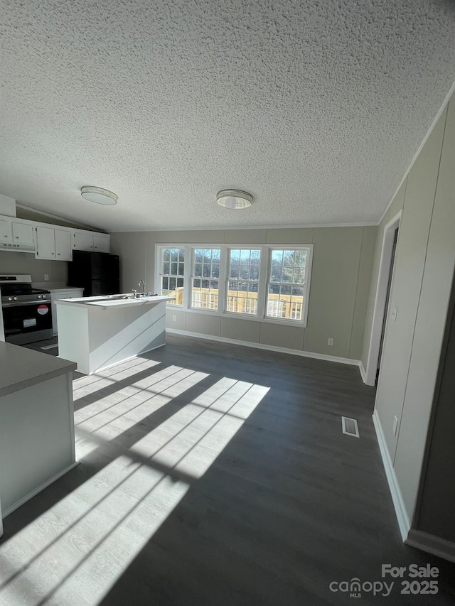 unfurnished living room with dark hardwood / wood-style floors