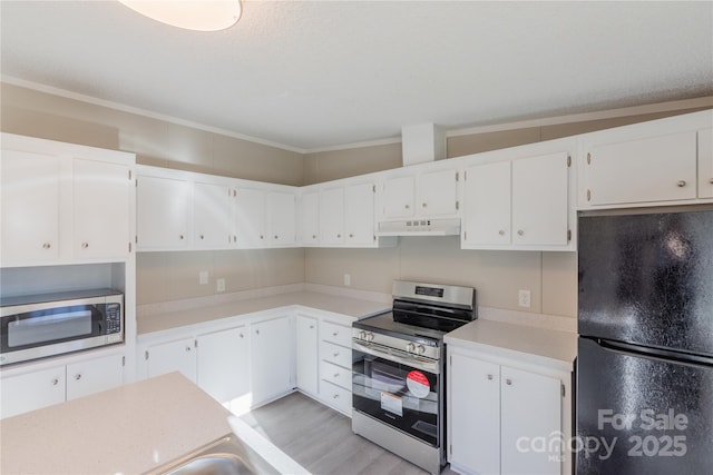 kitchen with white cabinets, stainless steel appliances, and light wood-type flooring