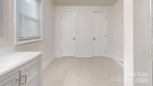 interior space featuring sink and light tile patterned floors