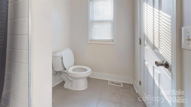 bathroom with plenty of natural light, tile patterned flooring, and toilet