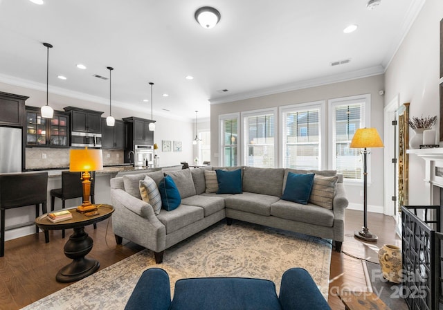 living room with wood-type flooring and crown molding