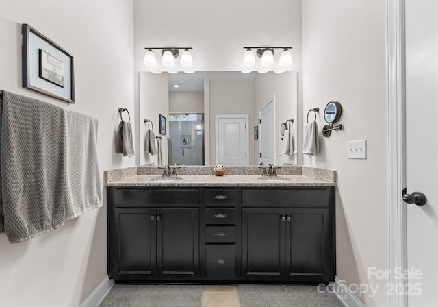 bathroom featuring tile patterned flooring, vanity, and walk in shower