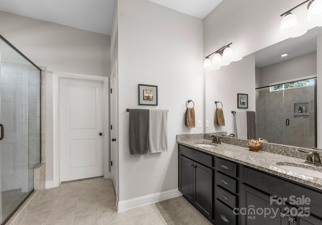 bathroom featuring tile patterned flooring, vanity, and a shower with shower door