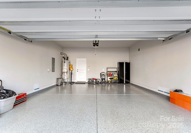 garage featuring gas water heater, a garage door opener, and electric panel