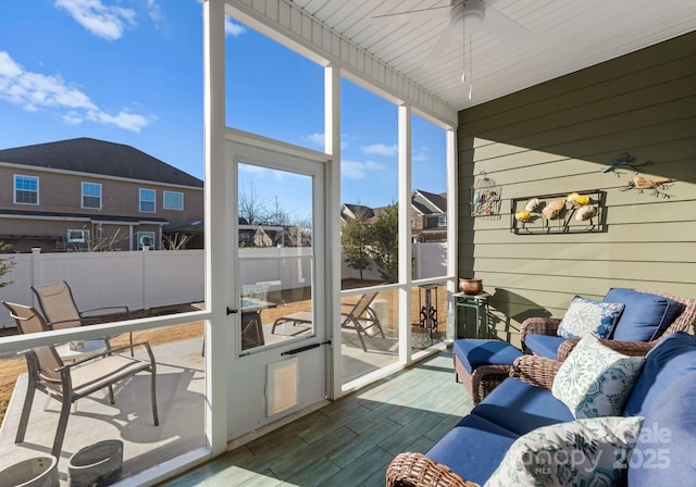 sunroom featuring ceiling fan