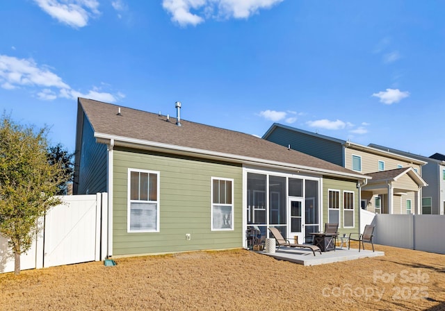 rear view of property with a patio area and a sunroom