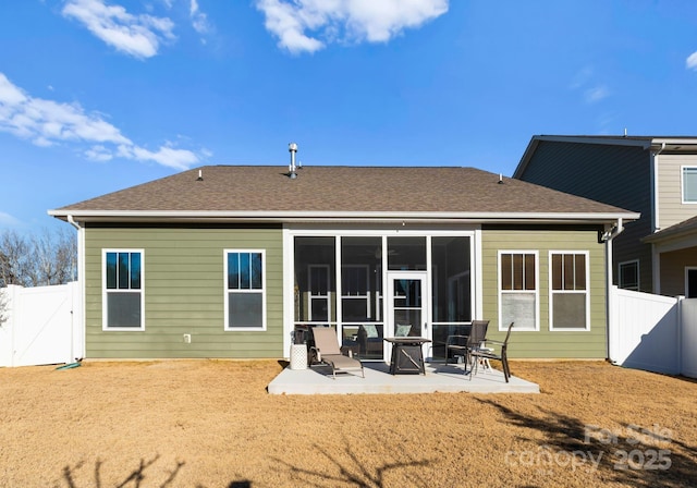 rear view of house featuring a patio and a sunroom