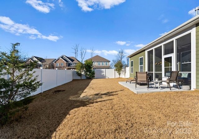 view of yard with a sunroom and a patio