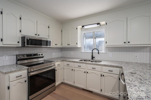 kitchen featuring white cabinetry, sink, light stone countertops, and appliances with stainless steel finishes