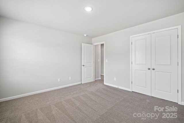 unfurnished bedroom with a closet and carpet