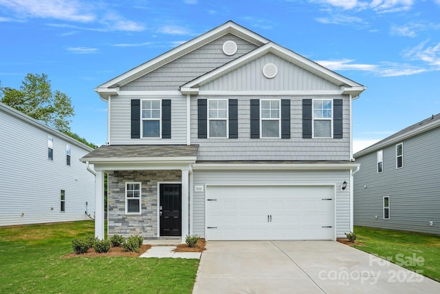 view of front of property with a garage and a front lawn