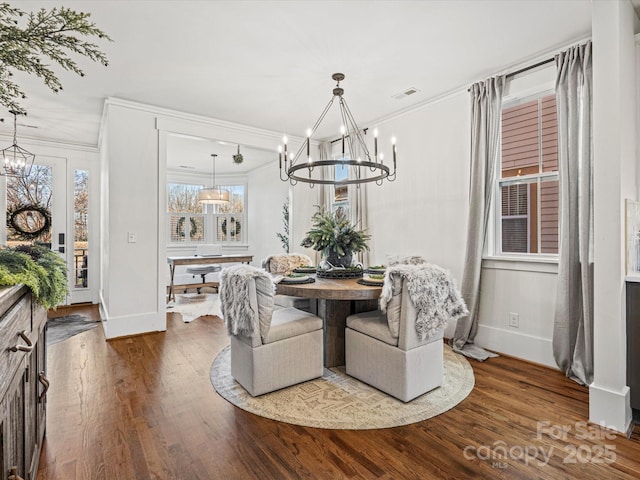 dining space with wood-type flooring and crown molding