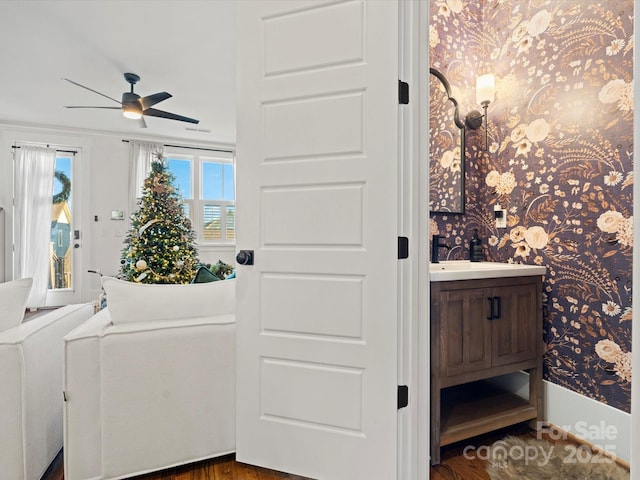 interior space featuring hardwood / wood-style floors, ceiling fan, plenty of natural light, and vanity