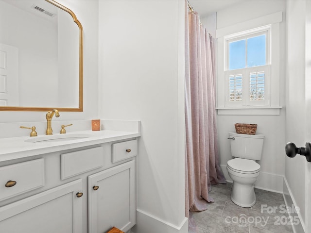 bathroom with tile patterned flooring, vanity, and toilet