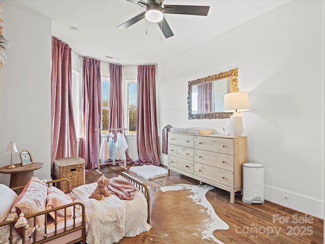 living area with ceiling fan and wood-type flooring