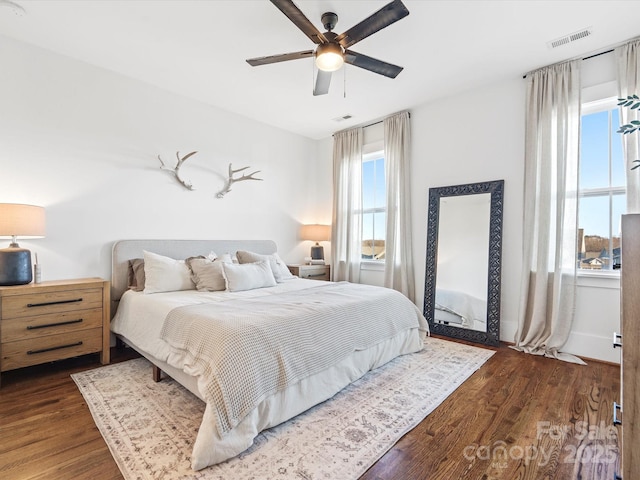 bedroom featuring ceiling fan and dark wood-type flooring