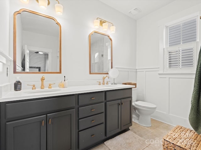 bathroom with tile patterned floors, vanity, and toilet