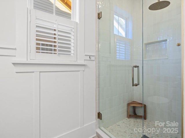 bathroom featuring a wealth of natural light and a shower with door