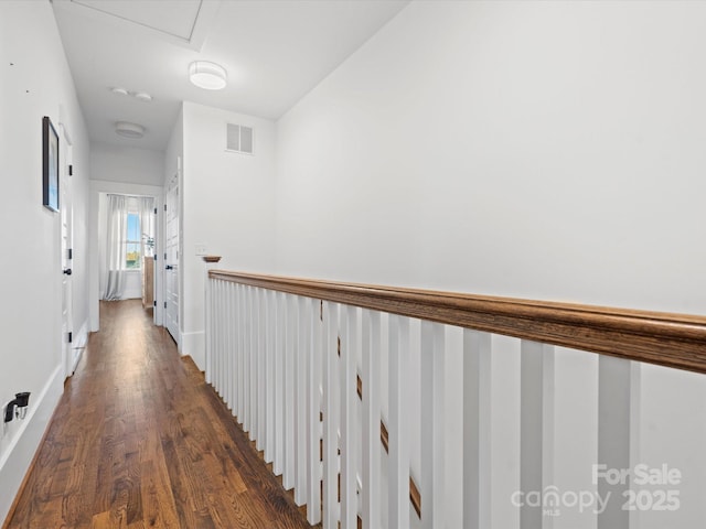 corridor with dark hardwood / wood-style flooring