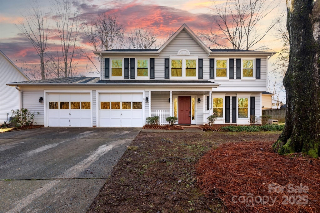 view of front of property with a porch and a garage