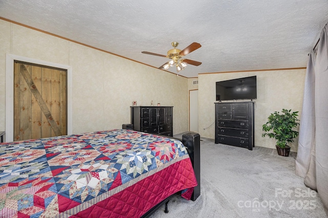 carpeted bedroom with ceiling fan, a textured ceiling, ornamental molding, and lofted ceiling