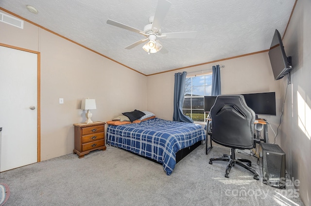 carpeted bedroom featuring ceiling fan, crown molding, and a textured ceiling