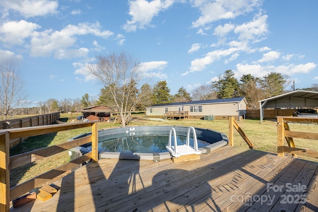 view of pool with a wooden deck and a yard