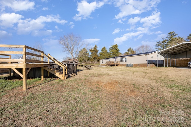 view of yard with a deck and a carport