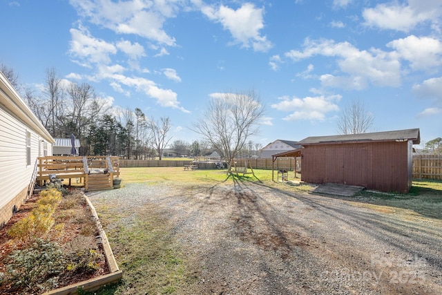 view of yard with a deck and a shed