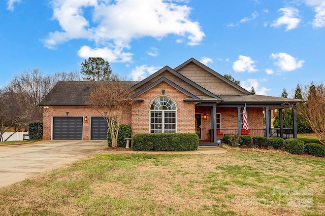 view of front facade with a porch, a garage, and a front yard