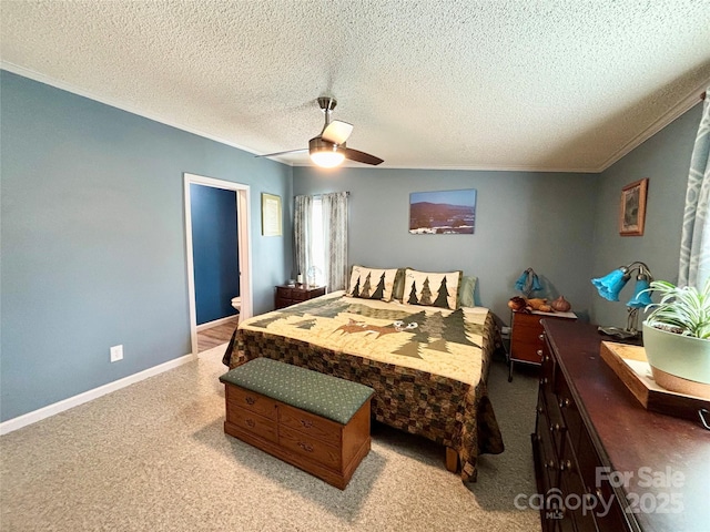 carpeted bedroom with a textured ceiling, ceiling fan, and ornamental molding