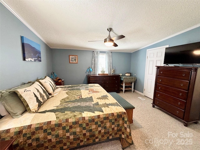 carpeted bedroom featuring a textured ceiling, ceiling fan, and crown molding